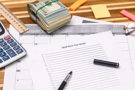 dollar with list for 2018 new year goals and penの写真素材
