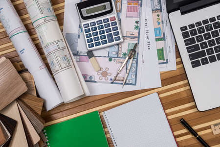house plan with laptop, phone, wooden samples and penの写真素材