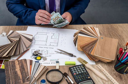 Designer counts the money for the work - house project.の写真素材