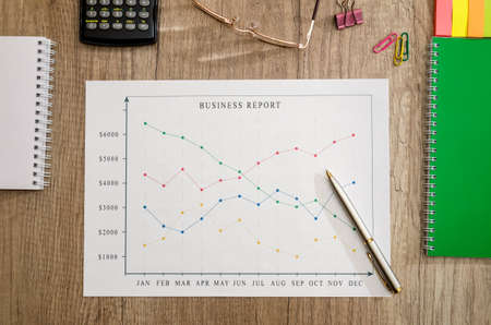 business concept - graphs, calculator, money and pen on deskの写真素材