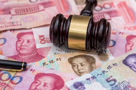 yuan on wooden hammer. close up.の写真素材