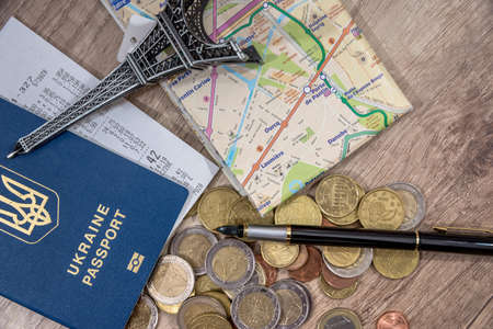 passport with US currency and map, toy eiffel tower, check for a background.
