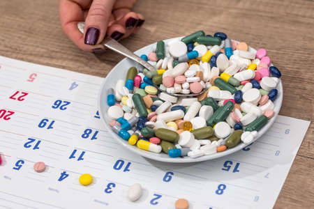 pills in plate on calendar. close up.の写真素材