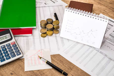 notepad, financial documents, calculator, pen and coinの写真素材