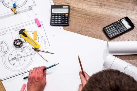 engineer measures the dimensions of the drawing.