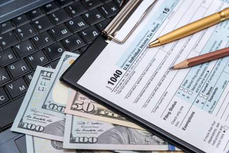 tax form 1040 with laptopの写真素材