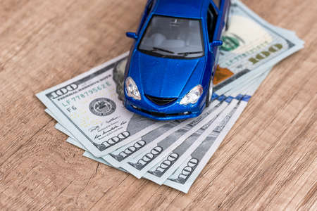 blue toy car with us dollar