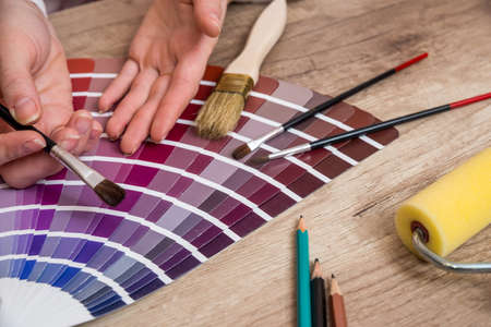 woman hand pointing to color samples