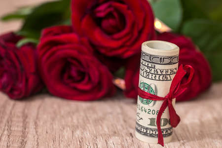beautiful roses with money on deskの写真素材