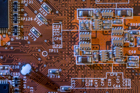 Macro shot of backside of orange computer circuit board