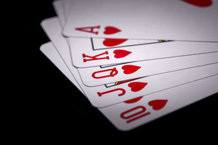Royal flush. Playing cards isolated on black backgroundの写真素材