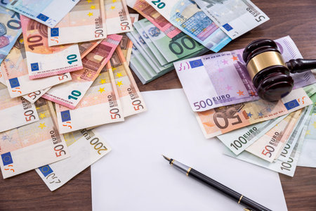 hammer with euro bills, empty note, penの写真素材
