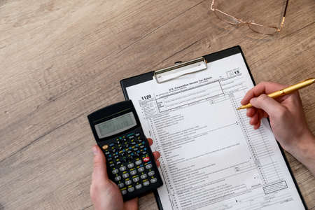 Man filing tax form 1120