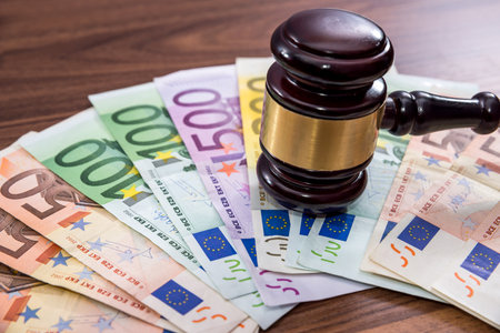 Law gavel with euro on wooden deskの写真素材