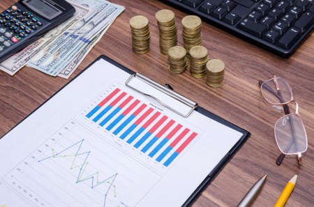 graph with tablet pc and money
