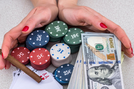 Stack of poker chips, money, card in two handsの写真素材