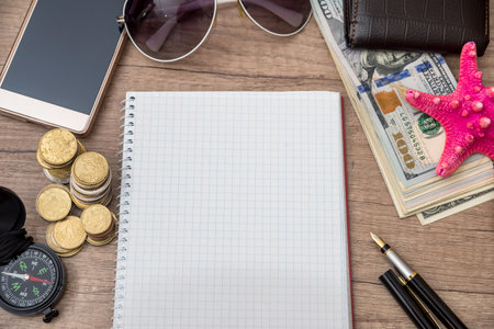 trip accessories - empty notepad, money, map and compassの写真素材