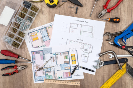 Construction plans with drawing tools and work tools.