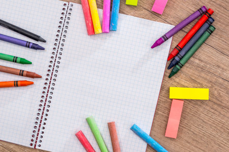 Blank notebook with pencils, chalk color on wood table.の写真素材
