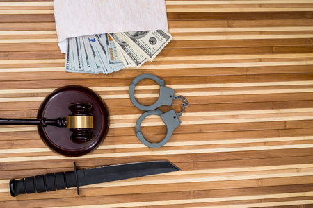 handcuffs, dollar, hammer judge and knife.の写真素材