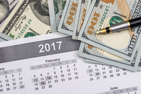 dollars with calculator on the calendar 2017.の写真素材