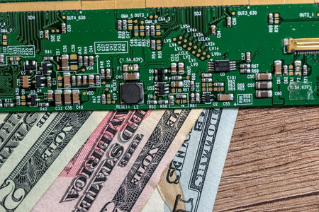 dollar bills from technology. green motherboard. close up.