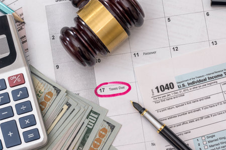 1040 tax form with gavel and dollars and pen.の写真素材