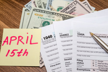 Official USA tax form 1040, calculator, pen and dollar and the day tax april 15の写真素材