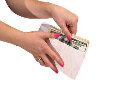 Womens hand showing envelope with dollars isolated on white background.