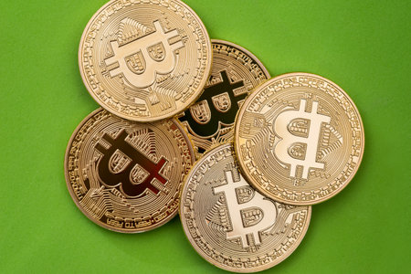 Golden Bitcoins - virtual money - isolated on greenの写真素材