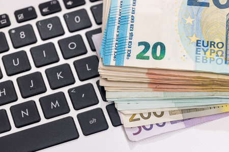 euro money on laptop. close upの写真素材