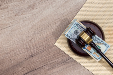 us money with wooden judges hammer on table, top viewの写真素材