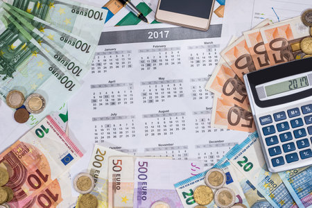 calendar, euros and calculator, coin placed on a table