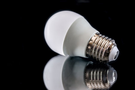 LED light bulb with reflection isolated on black. close up