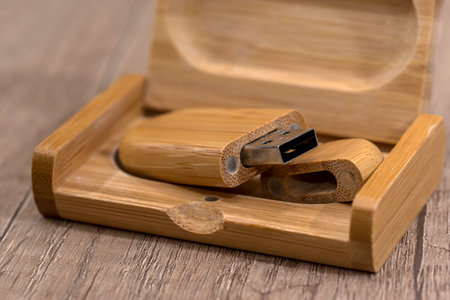 Wooden flash drive on wooden table.