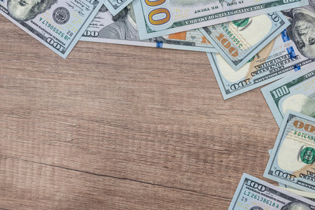 us dollar on top od wooden desk.の写真素材