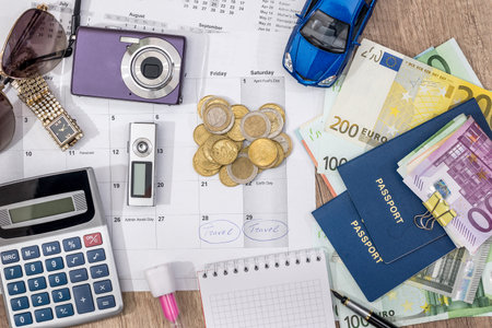 time to travel - passport, money, camera, watch, calculator, glasses, calendar toy car on wooden...