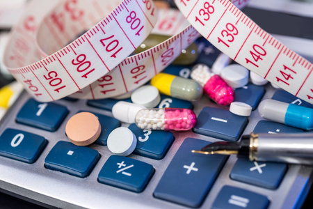 calculator with pills and measure tape. close up.の写真素材