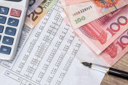 Budget text with calculator, yuan and pen on desk.の写真素材