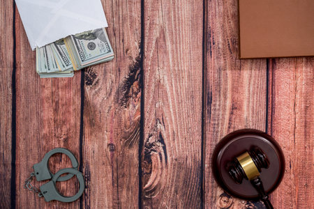 dollar in envelope with handcuff, wooden hammer.の写真素材