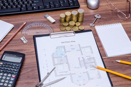 architectural drawings of the modern house with computer keyboard, calculator, notepad, pen, coin and pencilの写真素材