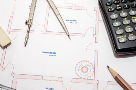 Architect's workspace with plan and pencil, calculator, ruler, compassの写真素材