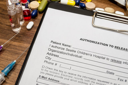 blank patient information with stethoscope, syringe and pillsの写真素材