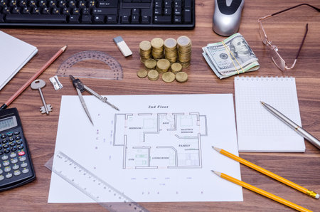 architectural drawings of the modern house with computer keyboard, calculator, notepad, pen, coin...