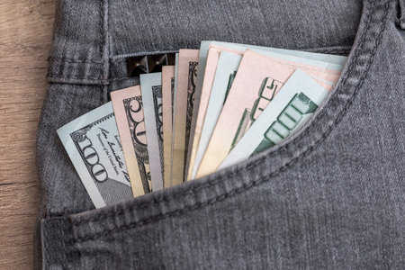 Dollar currency in jeans pocket ready for shoppingの写真素材