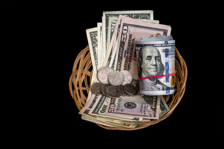 Basket with dollar isolated on black