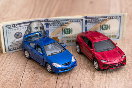 toy cars and dollar on deskの写真素材