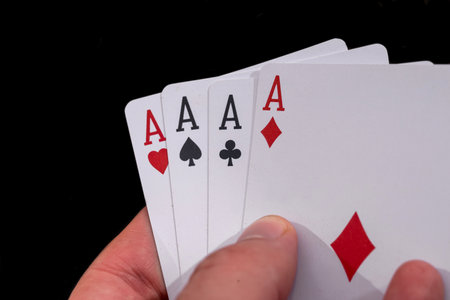 four aces in hand on black