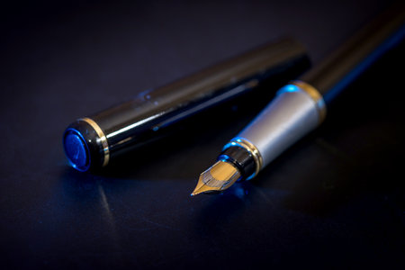stylish ink pen for the letter isolated on black backgroundの写真素材