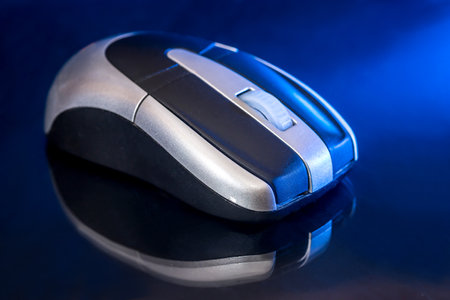 Black and silver mouse isolated on black blue background.